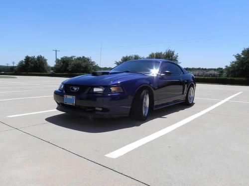 Midnight blue 2003 mustang gt 5 speed with beige leather interior.