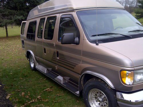 1996 ford customized raised top handicap van with remote lift.