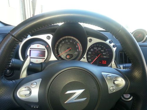 Pearl white nissan 370z, paddle shifters, 6 speed automatic, 320 hp loaded.