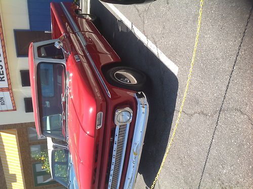 Red 1965 chevy c10 long bed pickup truck. fully restored