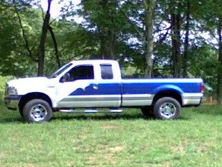 White and blue ford f 350 ext cab long bed