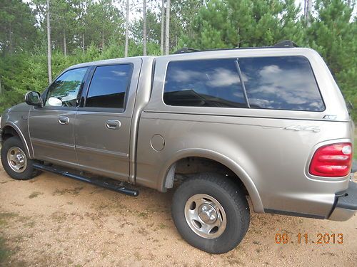 2001 ford f-150 xlt 4 x 4 crew cab with a.r.e. topper