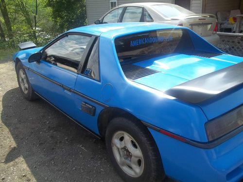 87 fiero 2.5l 5-speed, runs great- many extra parts included