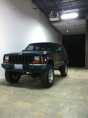 1999 black jeep cherokee sport with a 4.5" suspension lift
