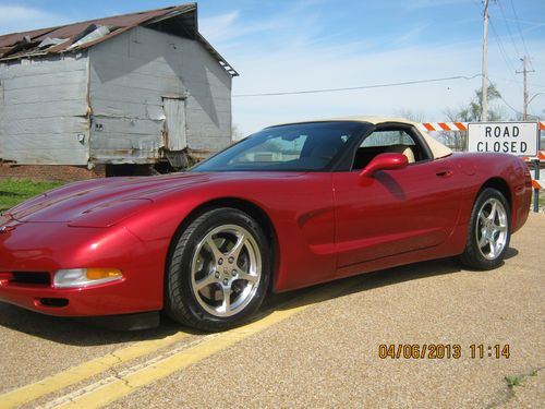 Excellent (mint) condition 2001 magnetic red convertible corvette with tan top.
