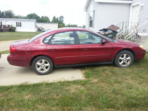 This is a red ford taurus 151,000 miles