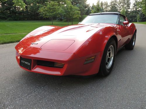 1980 corvette.red with oyster leather,all # match,glass ts,true actual miles!