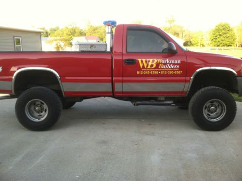 Eye catching, sharp, bright red, lifted 4 wheel drive with chrome rock guards