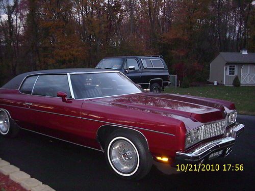 1973 chevy impala custom. excellent condition. burgundy with black vinyl roof.