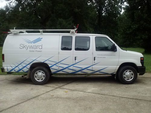 Very low miles white ford e-250 cargo van with many extras - great condition