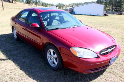 2003 ford taurus red $1550 very good on gas reliable v6