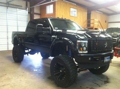 Blacked out ford f250 diesel 4 door 15.5 inch fabtech 4.0 lift