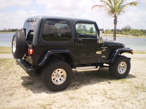 2001 jeep wrangler sport very low miles. black hard top 6 cylider rust free.