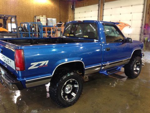 Blue, short bed, 3" body lift, 33" tires, headers and dual exhaust