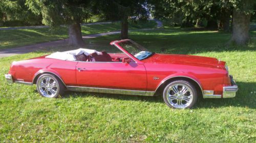 Red, convertable, black top, on chrome wheels, history